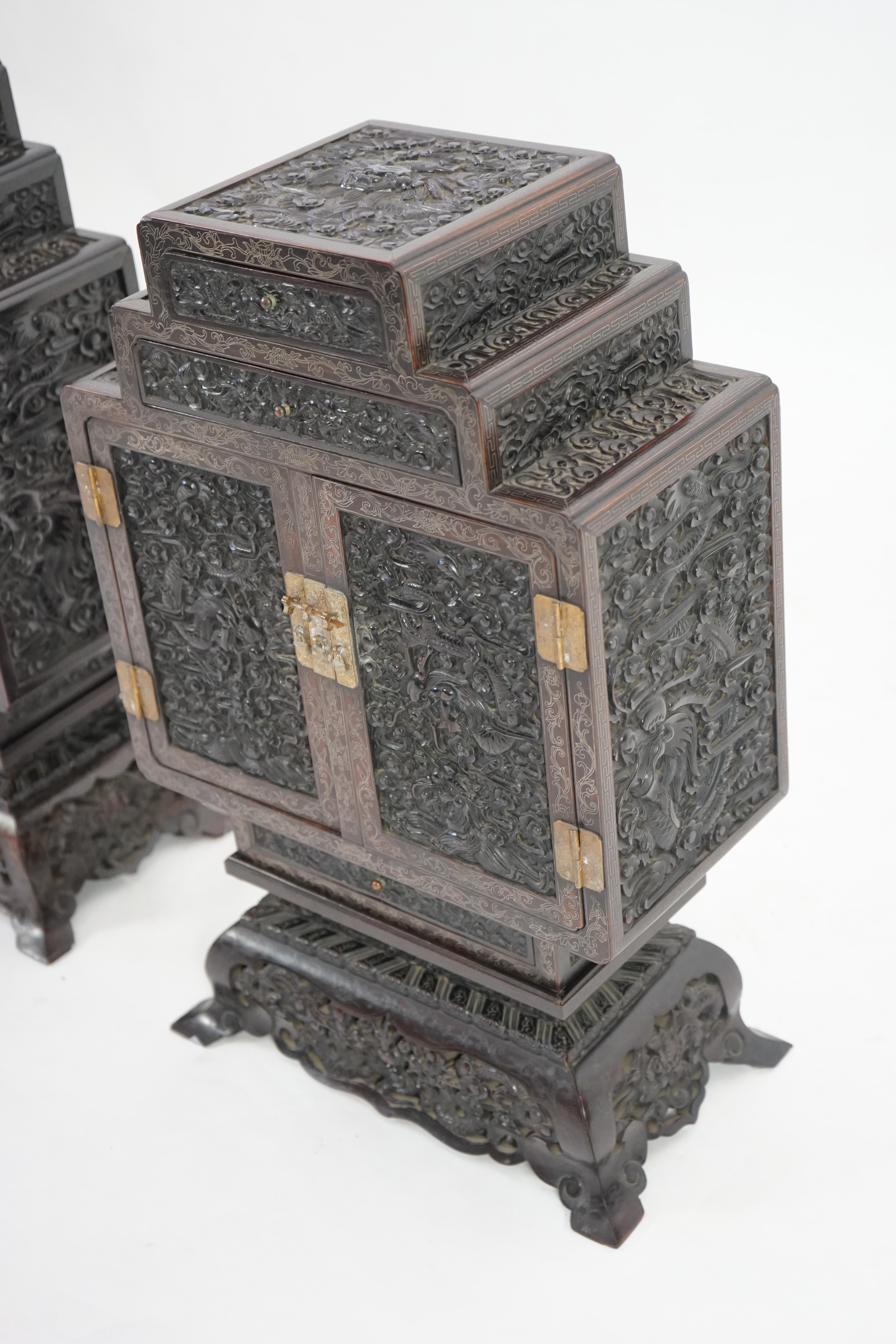 An important pair of Chinese carved zitan and silver wire inlaid ‘cloud and dragon’ curio cabinets and stands, duobaoge, probably Imperial, late Qing dynasty